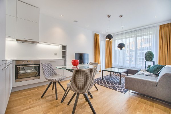two chairs with glass table on living room near window 1571453
